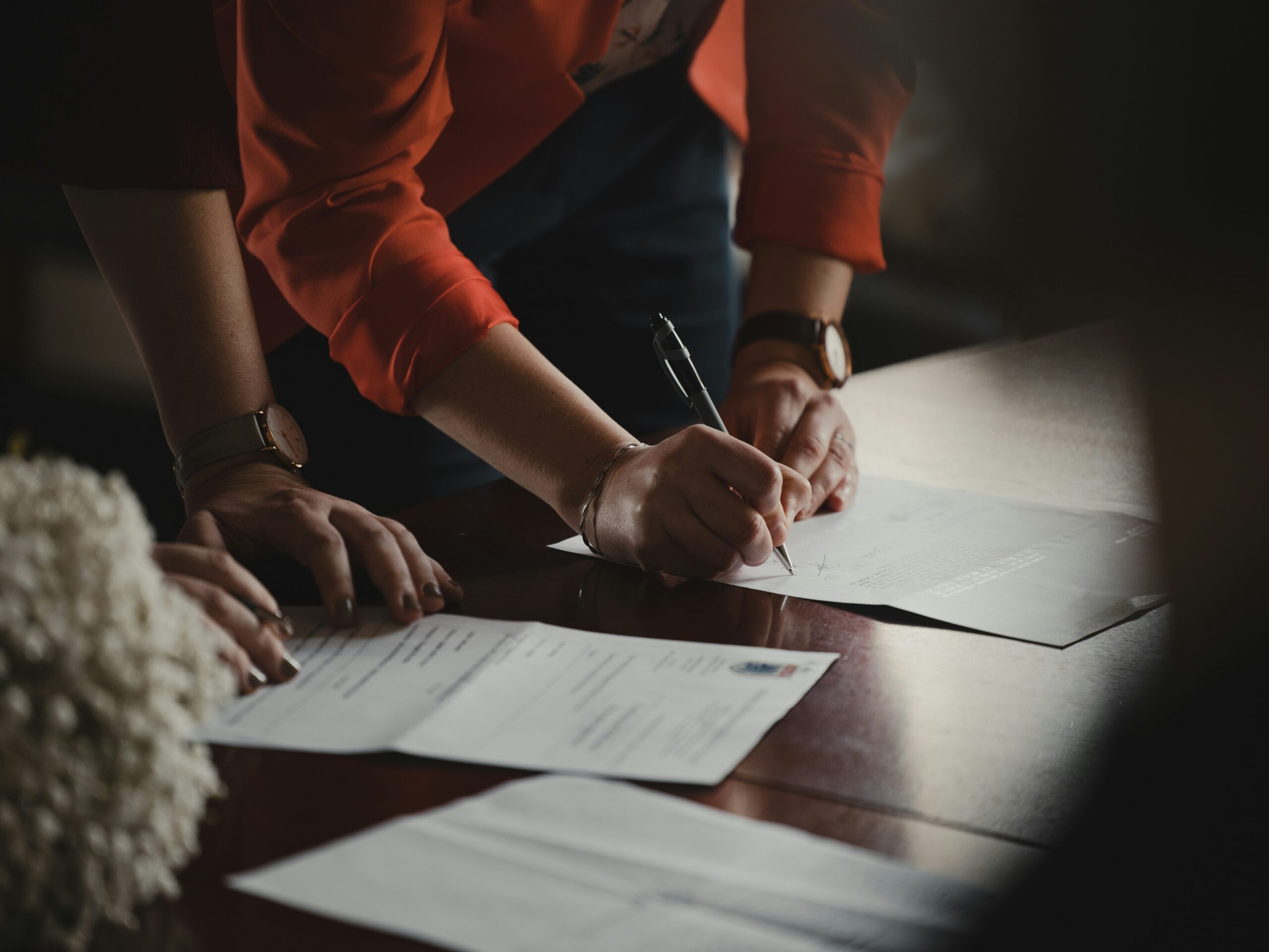 people signing papers