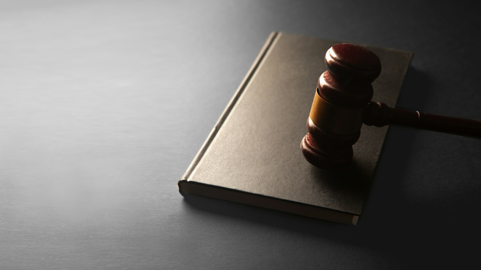 Gavel resting on a law book, representing the state juvenile court order required for SIJS