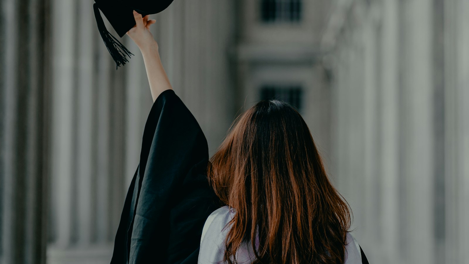 Young graduate in cap and gown planning for college and immigration status