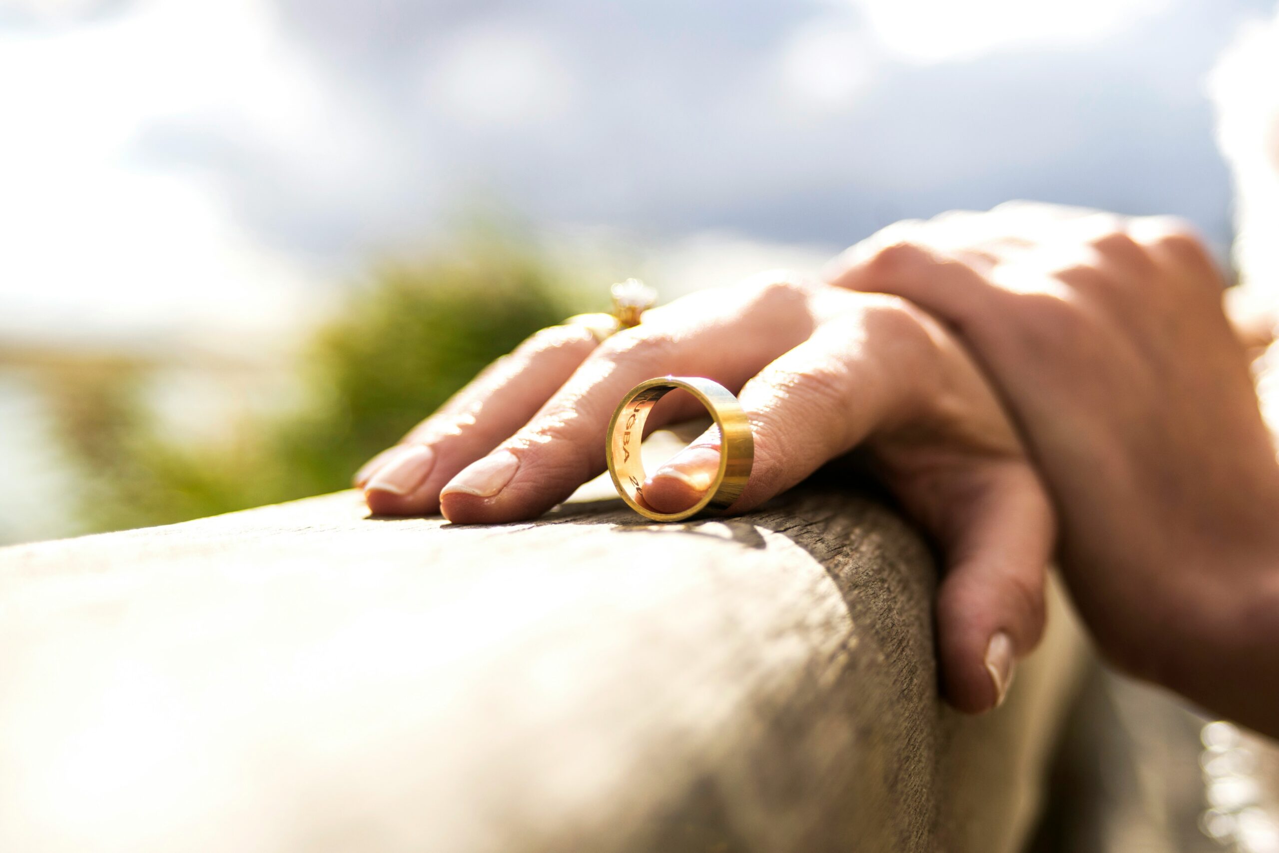 someone pushing a wedding ring off their finger